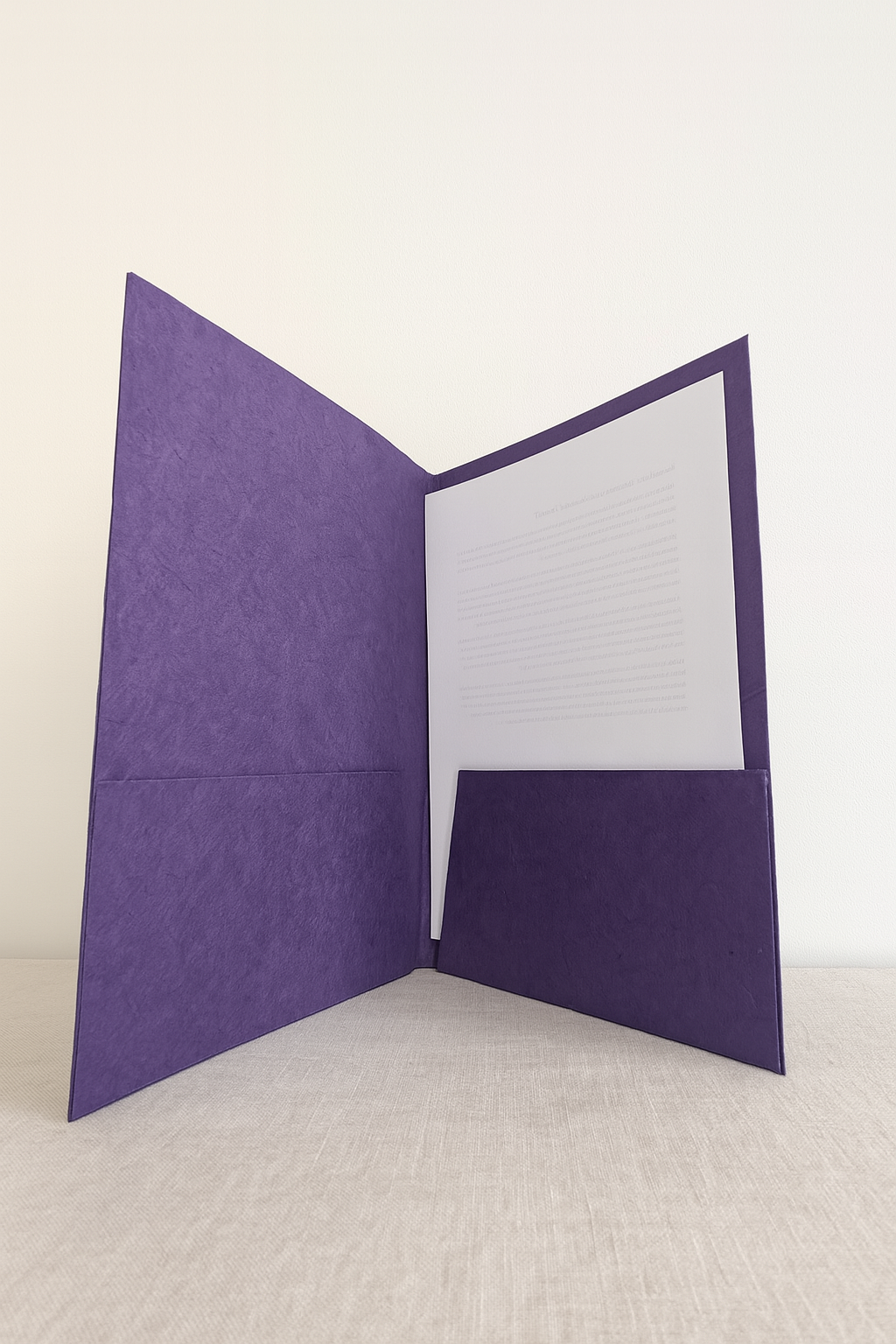 Interior view of a handmade Lokta folder showing dual purple paper pockets designed to hold A4 or letter-size documents.