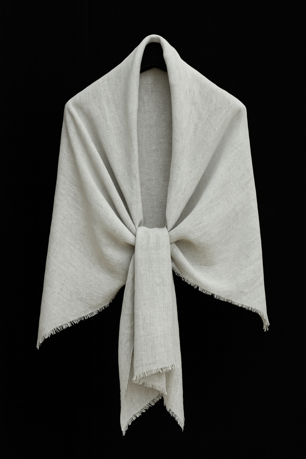 Light gray handwoven basket weave linen-silk stole draped in a soft V-shape with knotted front and fringe edges, displayed on a black background – artisan-crafted in Nepal