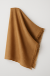 Golden brown herringbone merino wool stole with soft fringe edges, draped elegantly against a light neutral background – handcrafted in Nepal.