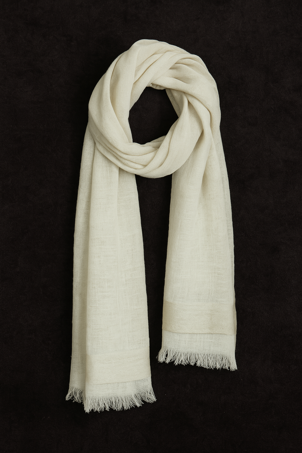 Off-white linen and silk blend basket weave stole with soft fringe edges, draped in a looped style against a dark textured background – handwoven in Nepal.
